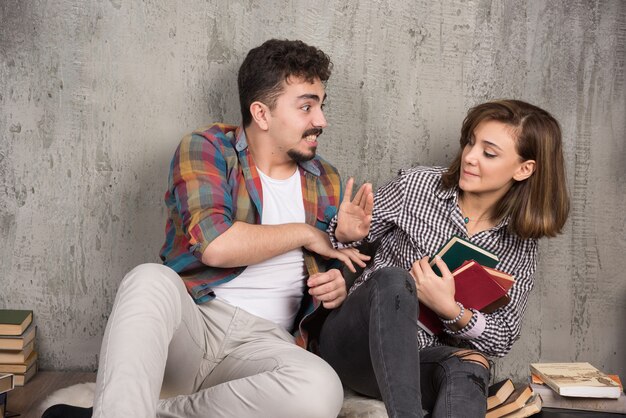 young woman doesn't give books to man 