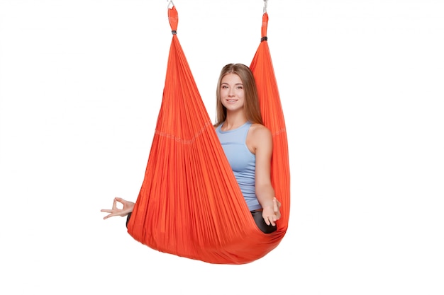 Young woman doing anti-gravity aerial yoga