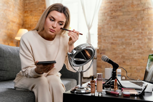 Young woman doing a beauty vlog at home