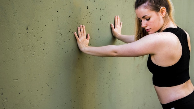 Young woman doing exercises at the street