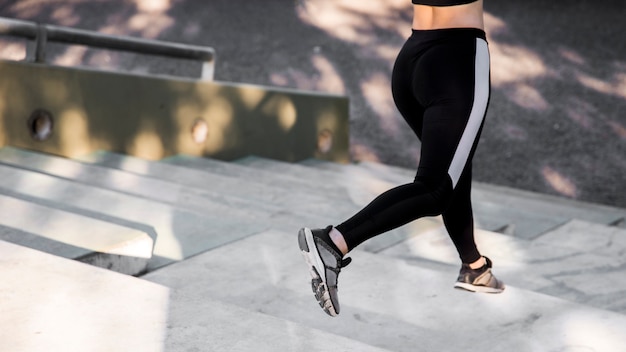 Free photo young woman doing exercises at the street