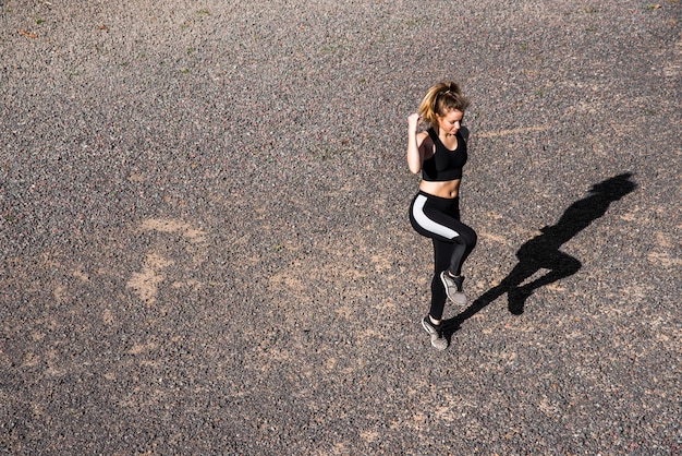 Young woman doing exercises at the street