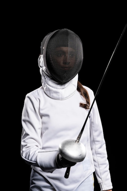 Free photo young woman doing fencing in special equipment