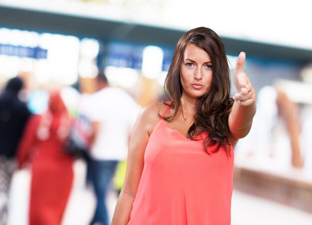 young woman doing a gun gesture