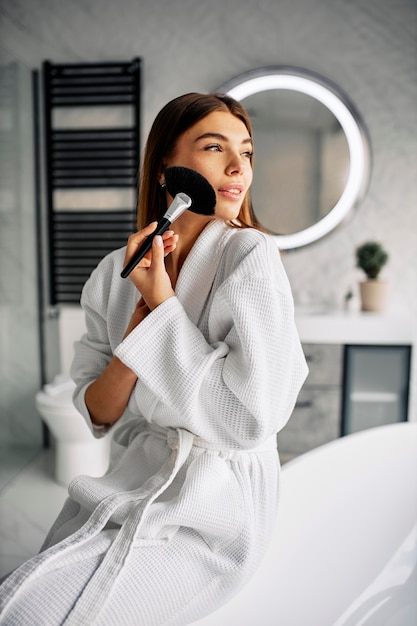 Free photo young woman doing her morning skincare routine