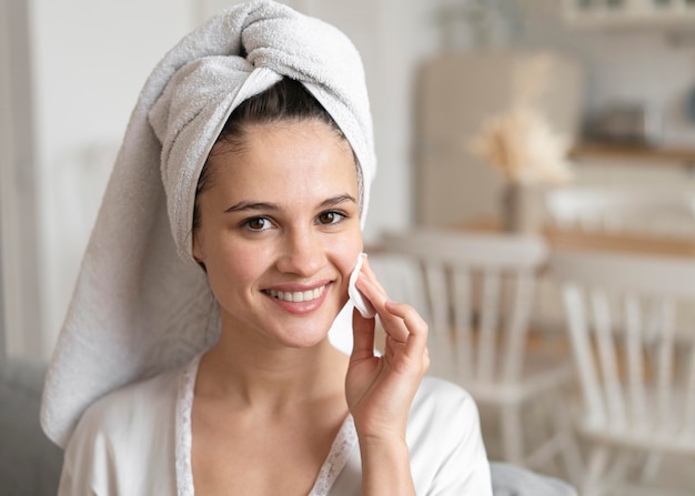 Free photo young woman doing a self care treatment at home