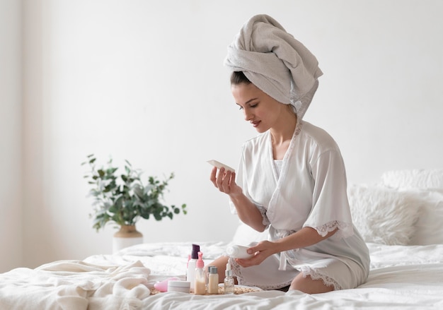 Free photo young woman doing a self care treatment at home