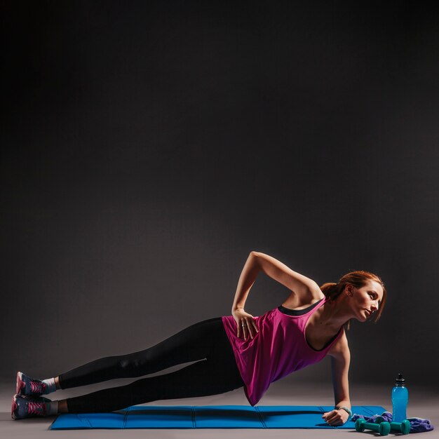 Young woman doing side plank