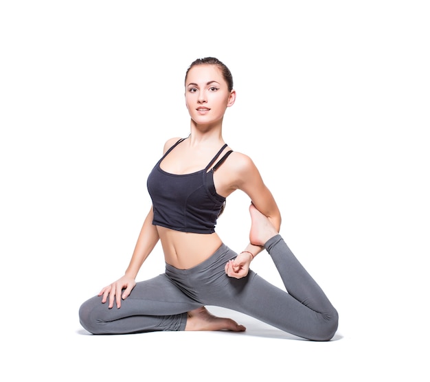 Young woman doing yoga on white background