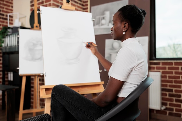 Free photo young woman drawing during art class