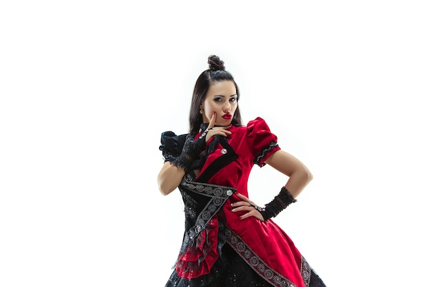 The young woman dressed in medieval style posing at studio as marquise