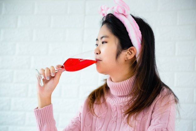 若い女性はワインの飲み物を飲む