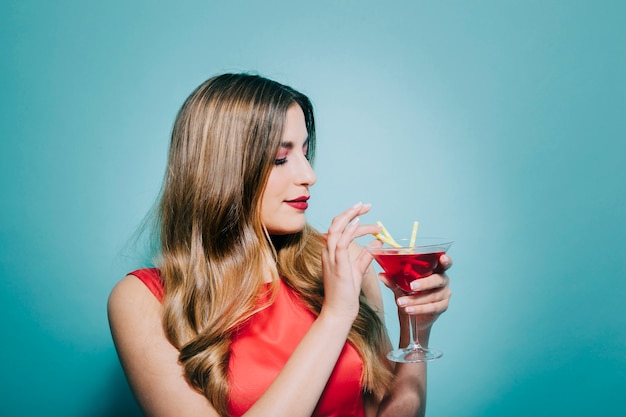 Young woman drinking cocktail