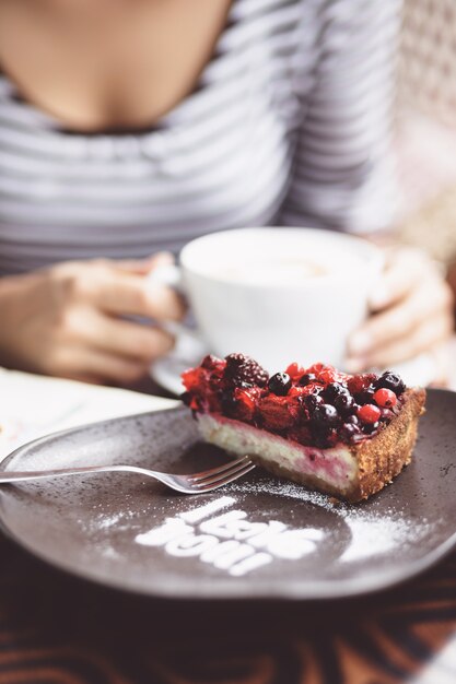 Young woman drinking coffee in urban cafe