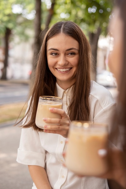 young woman drinking iced coffee