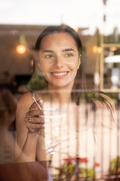 young woman drinking iced coffee