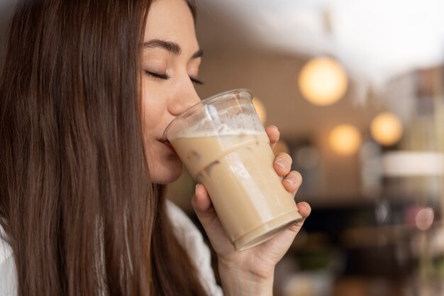 young woman drinking iced coffee
