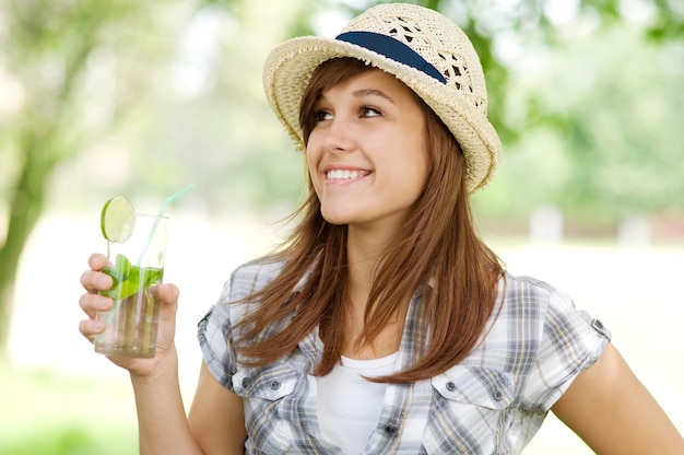 Young woman drinking mojito