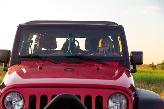 A young woman driving an suv in the countryside