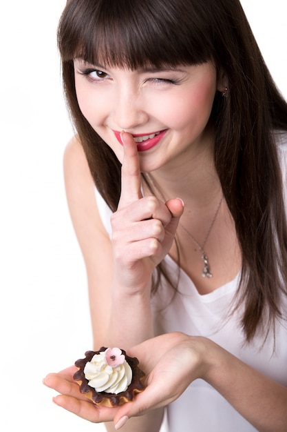 Young woman eating in secret