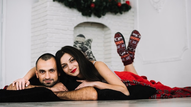 Young woman embracing man on floor