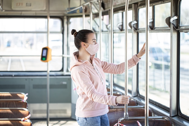 A young woman in an empty public transport during the pandemic. Coronavirus.