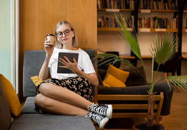 Young woman enjoying coffee at the library