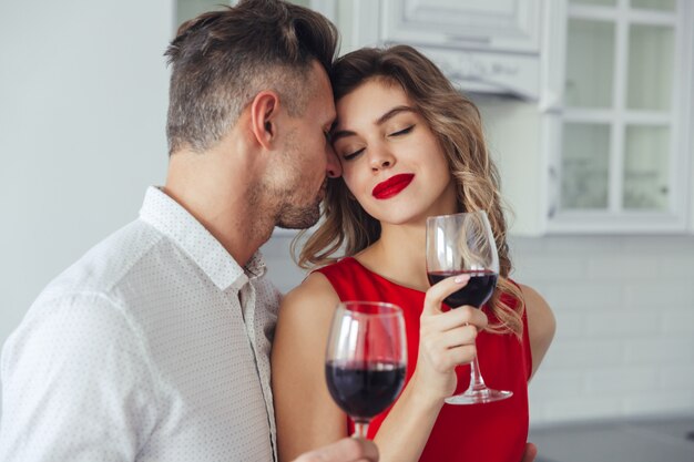 Young woman enjoying kisses of her handsome man