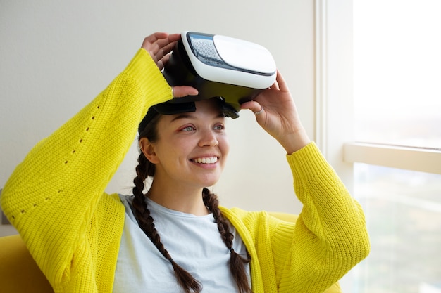 Free photo young woman enjoying new technology vr glasses