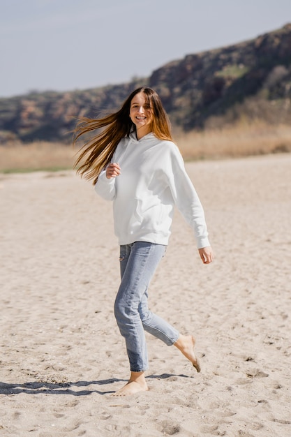 Foto gratuita giovane donna che gode della brezza dell'oceano