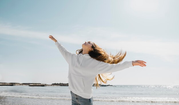 Young woman enjoying the ocean breeze