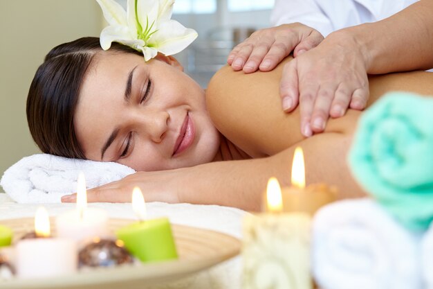 Young woman enjoying shoulders massage