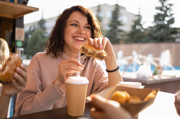 Free photo young woman enjoying some street food