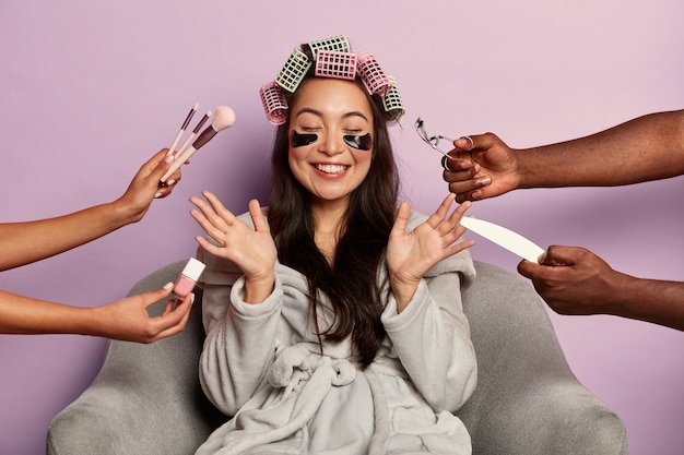 Free photo young woman enjoys beauty spa at home siting in bathrobe