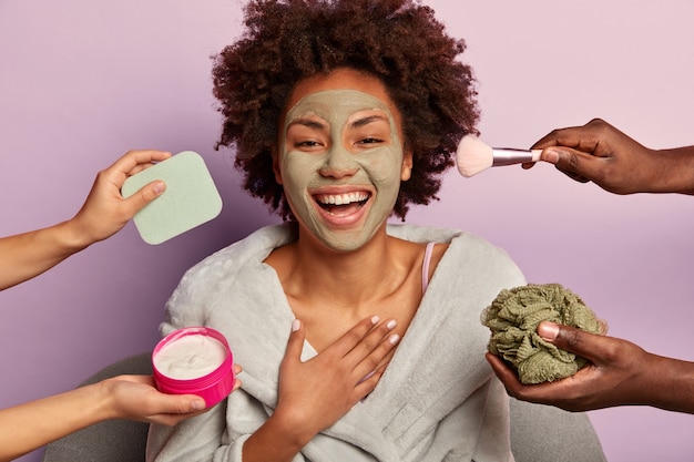 Young woman enjoys beauty spa at home siting in bathrobe