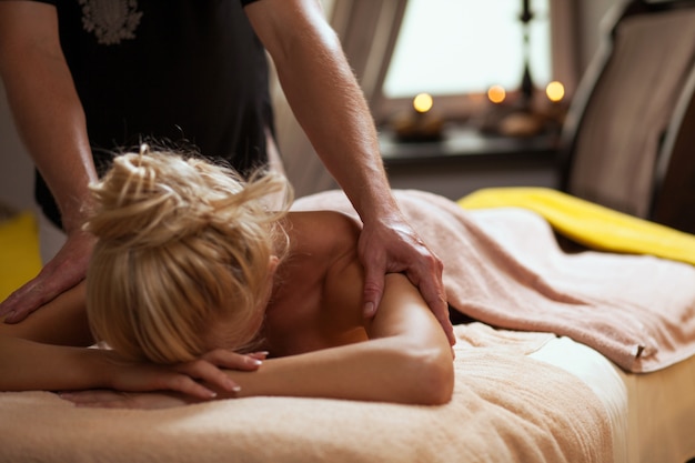 Young woman enjoys massage in a spa