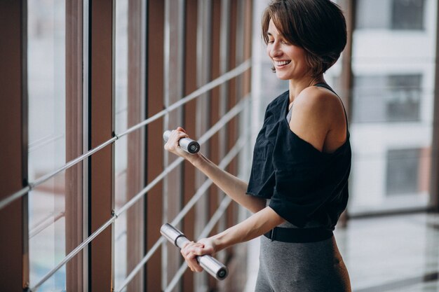 Free photo young woman exercising at the gym