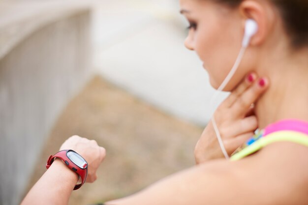 Young woman exercising outdoor. My pulse is fine so I can continue