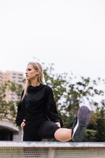 Young woman exercising on street