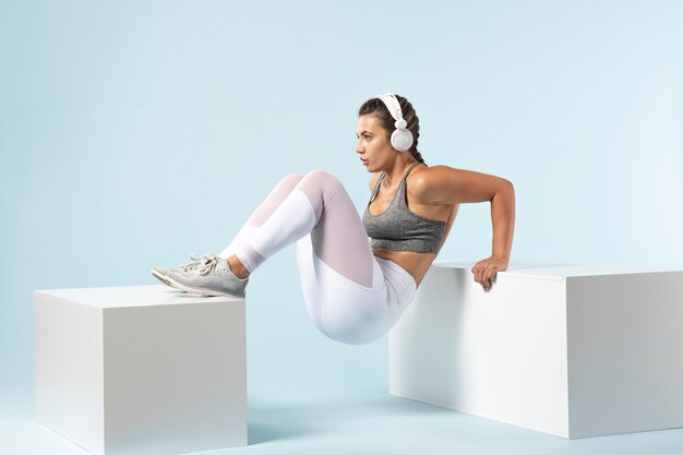 young woman exercising with her headphones on