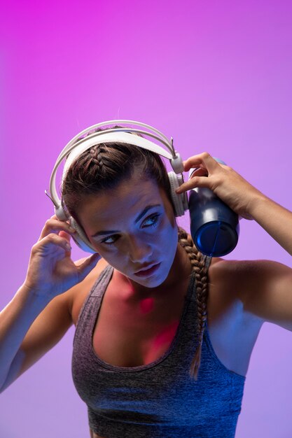 Young woman exercising with her headphones on
