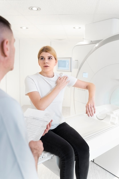 young woman explaining her shoulder pain