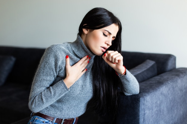 Young woman feel sick cought on couch at home