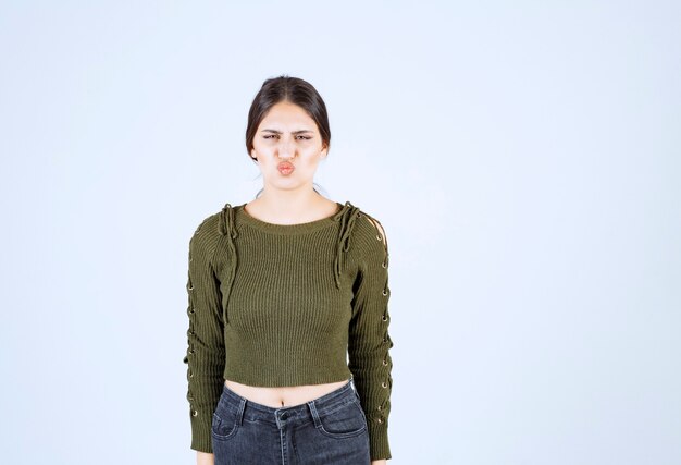 young woman feeling mad on white background.