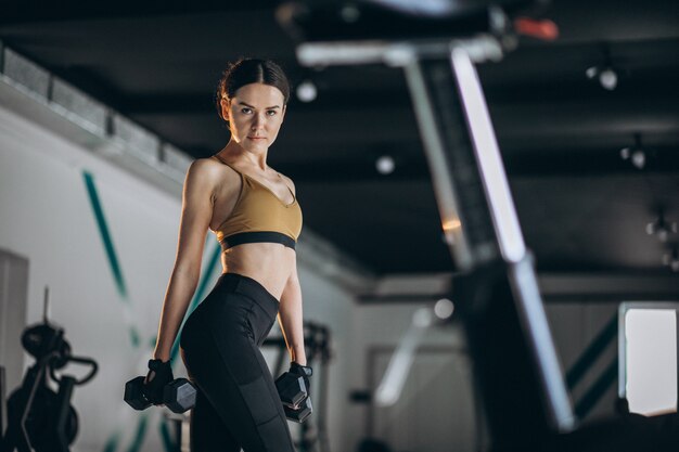 Young woman fitness trainer at the gym