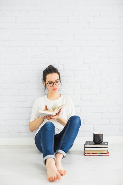 Young woman flipping pages of book