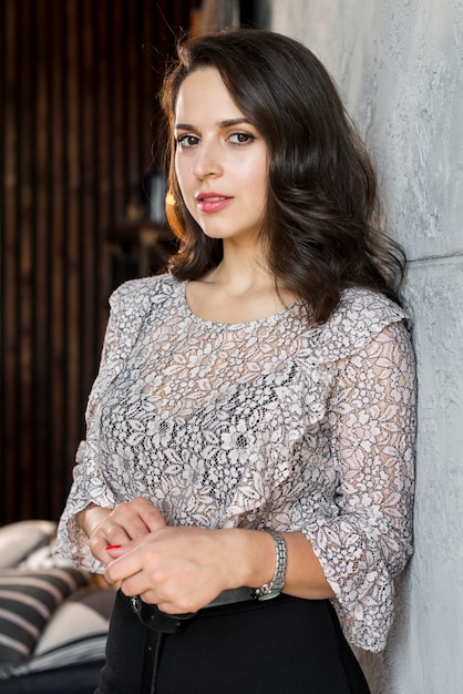 Young woman in floral top looking at camera