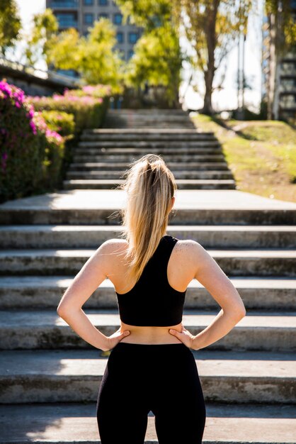 Young woman in front of stairs