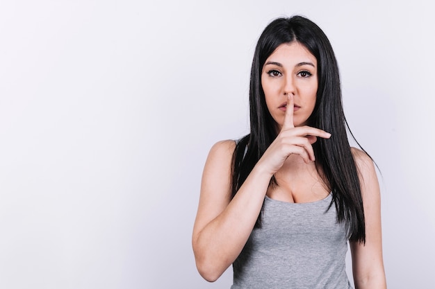 Young woman gesturing silence