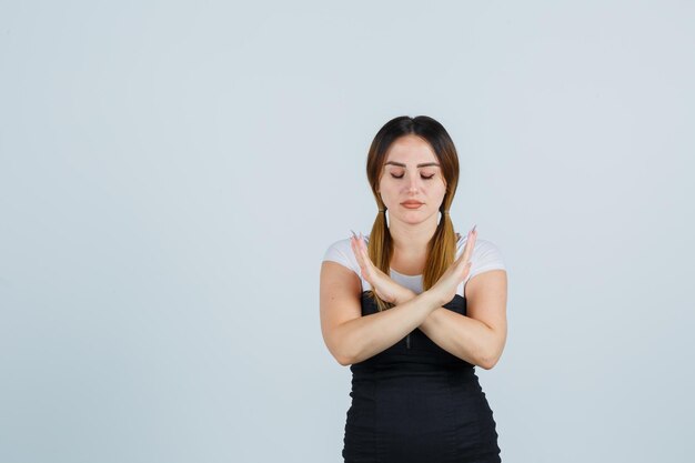 Young woman gesturing x sign